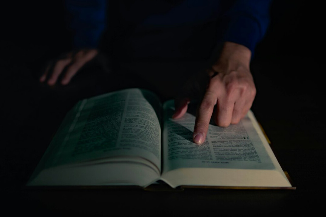 person reading mystery book at night