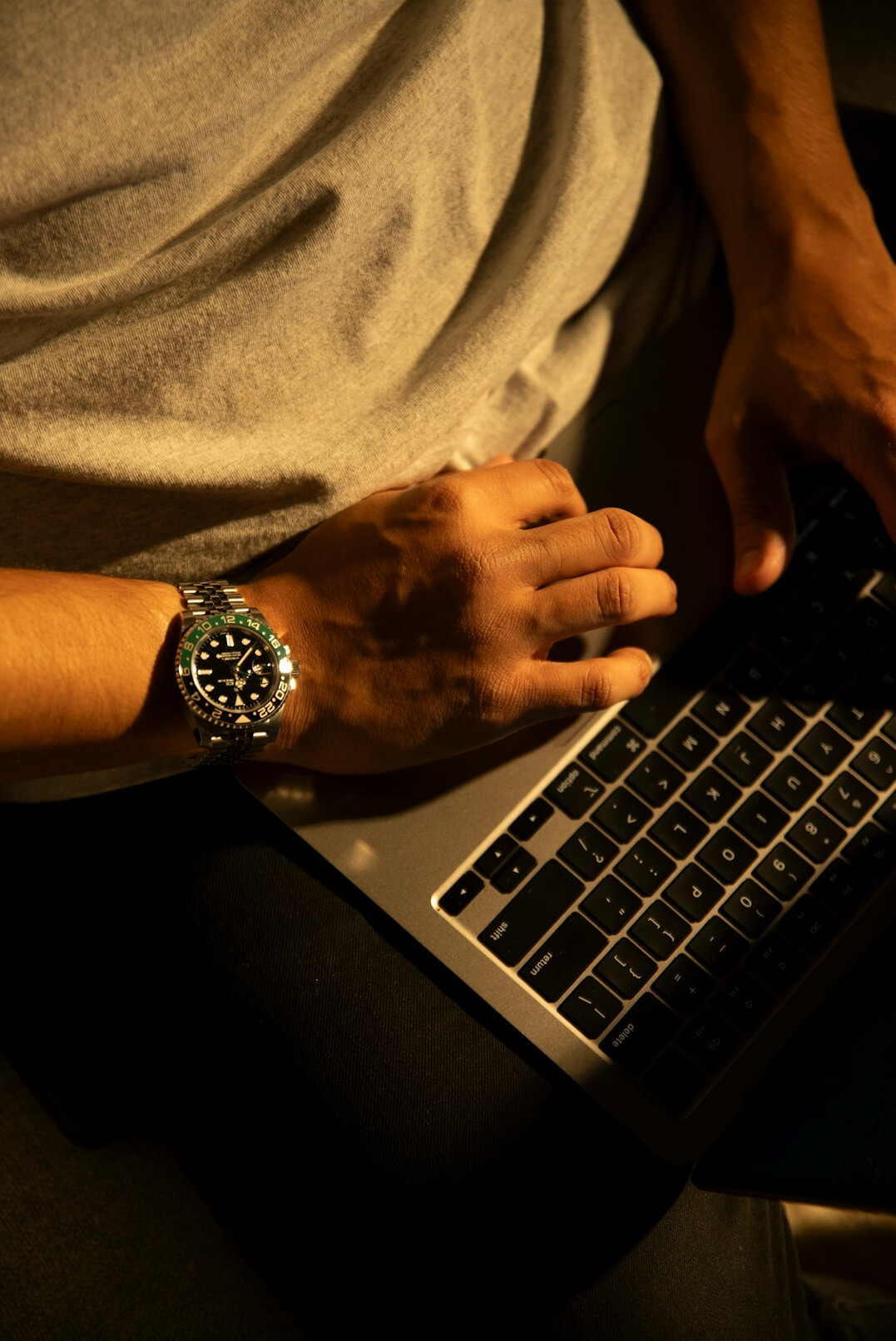 writer typing on laptop at night