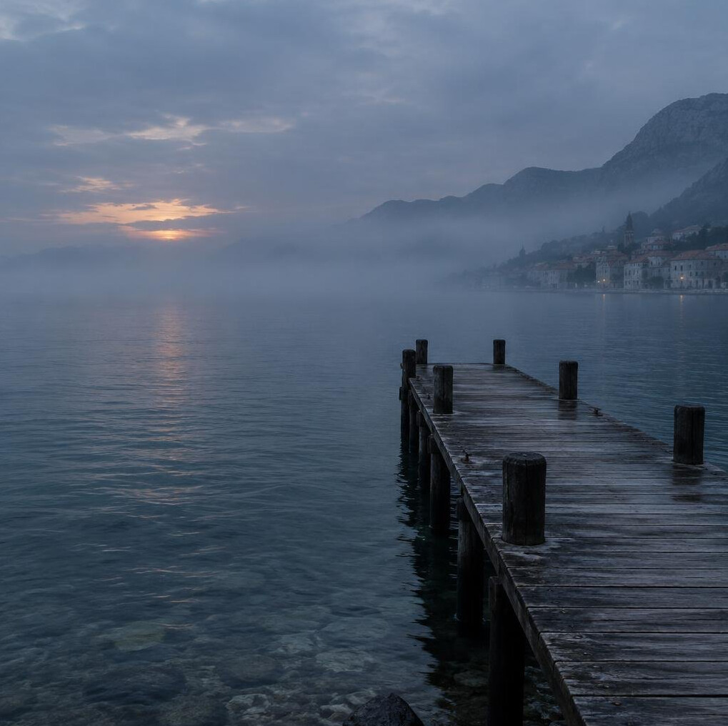 Foggy harbor pier at dusk along the Adriatic coast